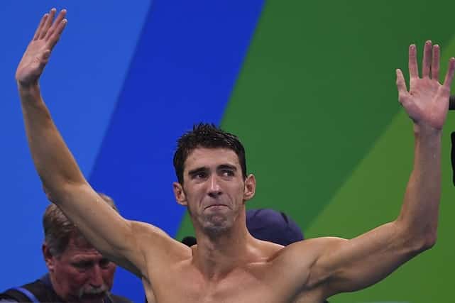 Gold medallist USA's Michael Phelps, reacts after the Men's swimming 4 x 100m Medley Relay Final at the Rio 2016 Olympic Games at the Olympic Aquatics Stadium in Rio de Janeiro on August 13, 2016. / AFP PHOTO / GABRIEL BOUYS