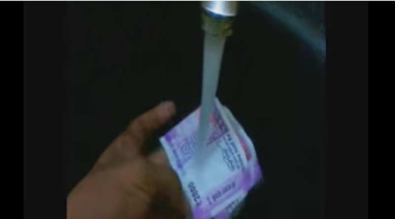 A Man is washing a Rs. 2000 Note and The Video Goes Viral