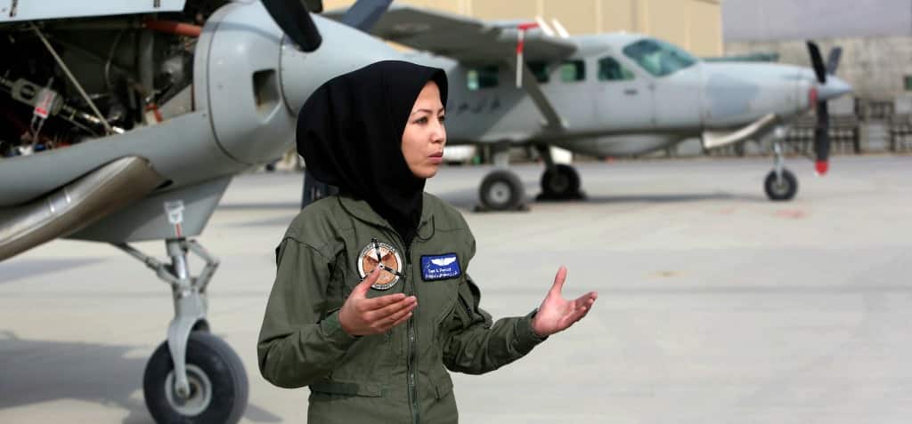 In this Monday, Nov. 21, 2016, photo, Afghanistan's first couple pilot, Captain Safia Ferozi, 26, speaks during an interview with the Associated Press after her flight, at the Afghan military airbase in Kabul, Afghanistan, (AP Photo/Rahmat Gul)