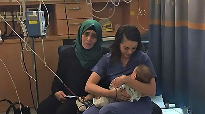  heartwarming photo of an Israeli nurse breastfeeding a Palestinian child 