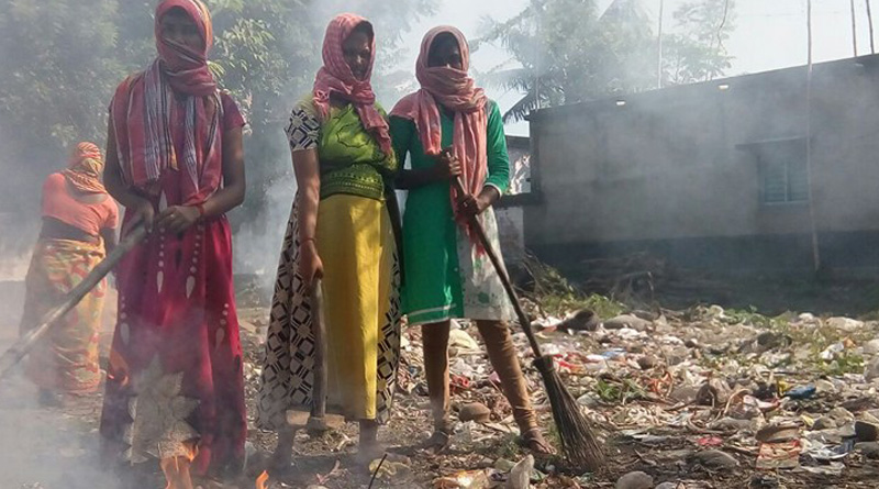 Women take step to clean the area to protect people from dengue