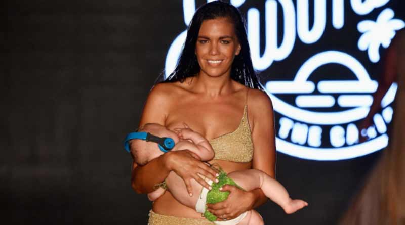 This swimsuit model walked the ramp breastfeeding her baby