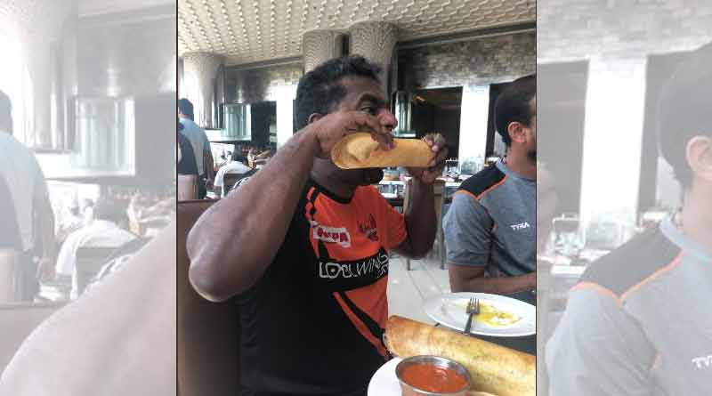 Muttiah Muralitharan attacks a 'dosa' during breakfast