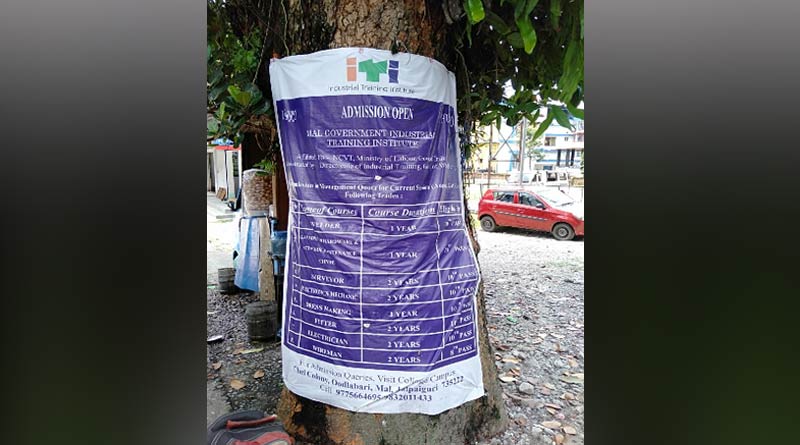 Government agencies flex and banner fixed on tree in Malbazar