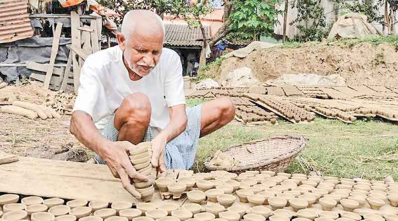 70 years old Patiram of Hooghly is busy to make clay lamp before Diwali