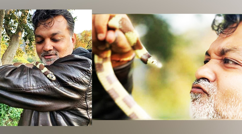 In between shoot, director Srijit Mukherjee poses with snake