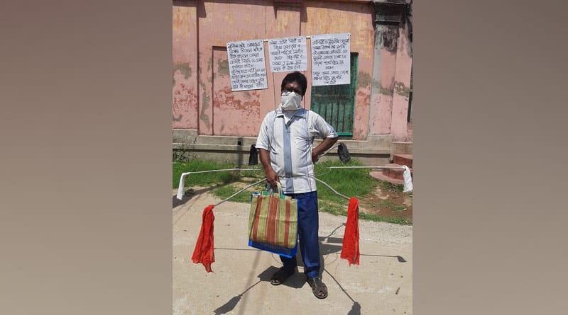সংক্রমণ ঠেকাতে অভিনব পন্থা, লোহার খাঁচা পরে রাস্তায় যুবক