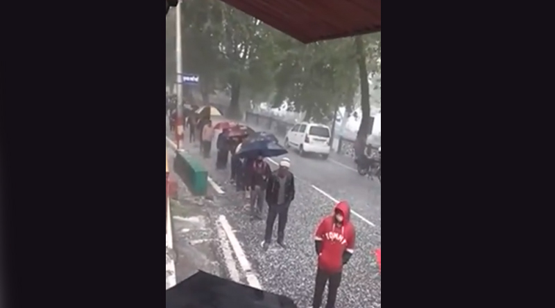 People brave hailstorm to buy liquor at shop on Mall Road in Nainital