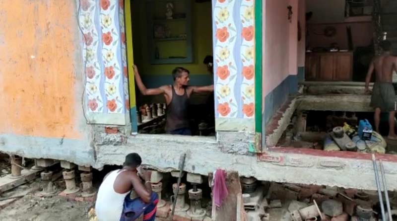 A house shifted from another place by help of machine at Nabadwip