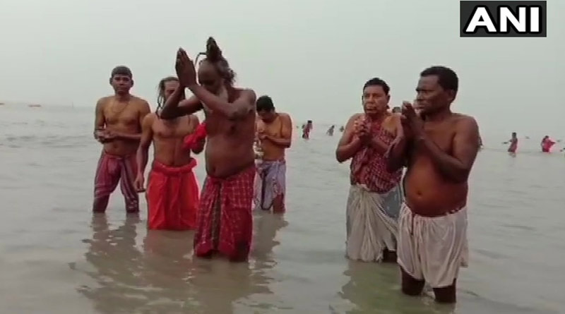 Devotees and hermits take holy dip at Gangasagar