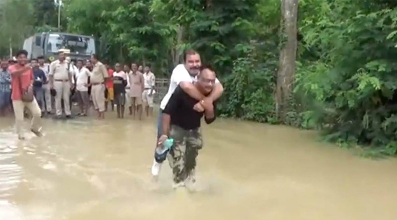 An Assam BJP MLA criticised for ‘piggyback ride’ in flood waters | Sangbad