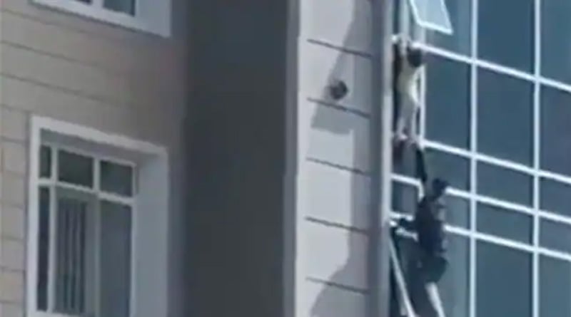 Kazakhstan Man Risks His Life to Save child Hanging From Eighth Floor Window | Sangbad Pratidin