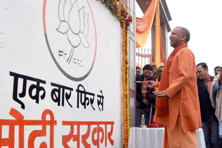 Yogi Adityanath starts vote campaigning by drawing Padma on the wall of temple। Sangbad Pratidin
