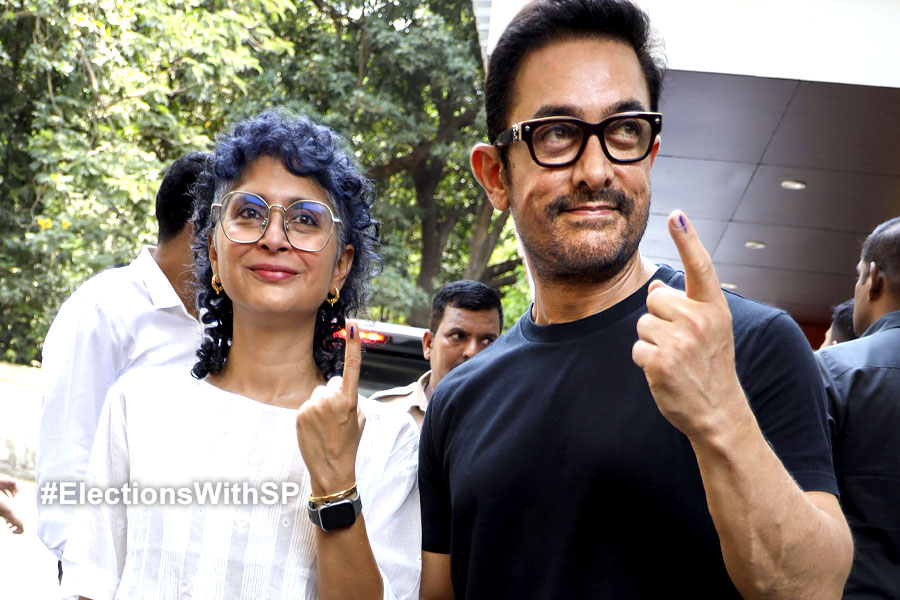 Aamir Khan, Kiran Rao show their inked finger after casting votes
