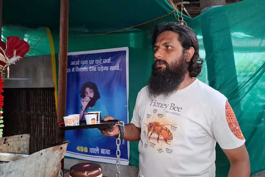 The shop is called '498A Tea Cafe' and the young man in handcuffs serves tea in Rajasthan