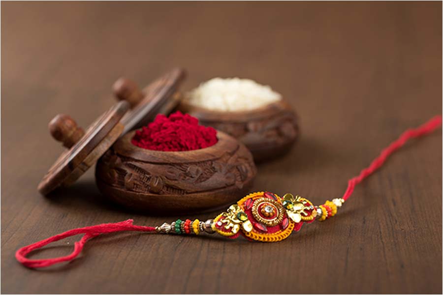 Why do sisters tie three knots on their brothers hands while tying the rakhi on Rakhi Purnima