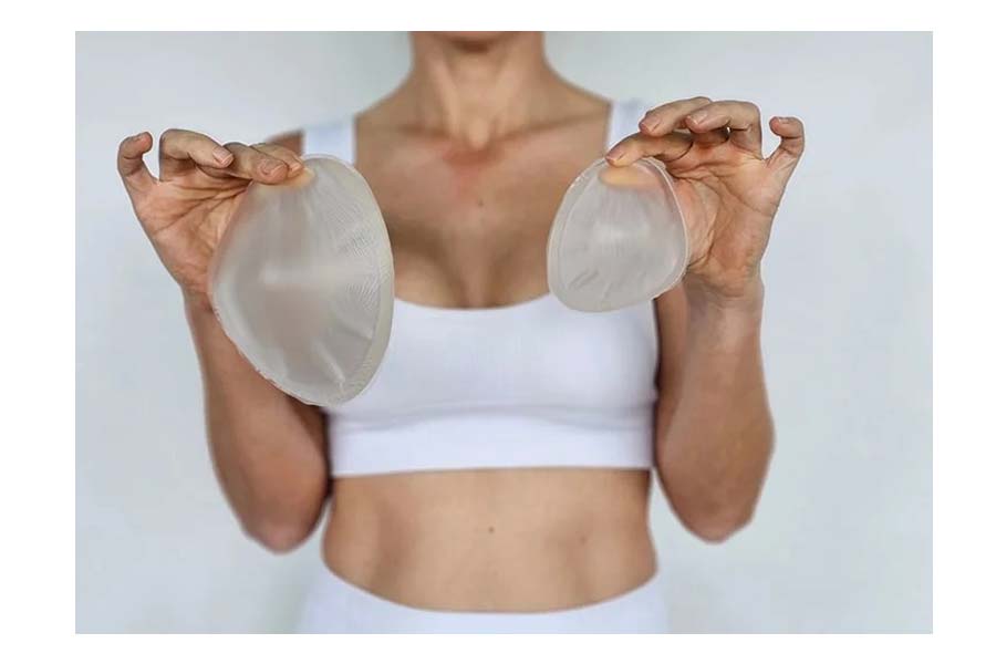What is a breast implant, and why is Sherlyn Chopra deciding to remove hers due to physical discomfort

