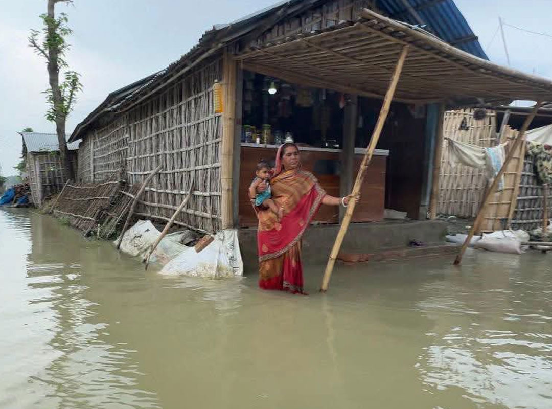 government doctor is examining patients while floating in a boat, wearing a life jacket, in Bhutni, Maldah